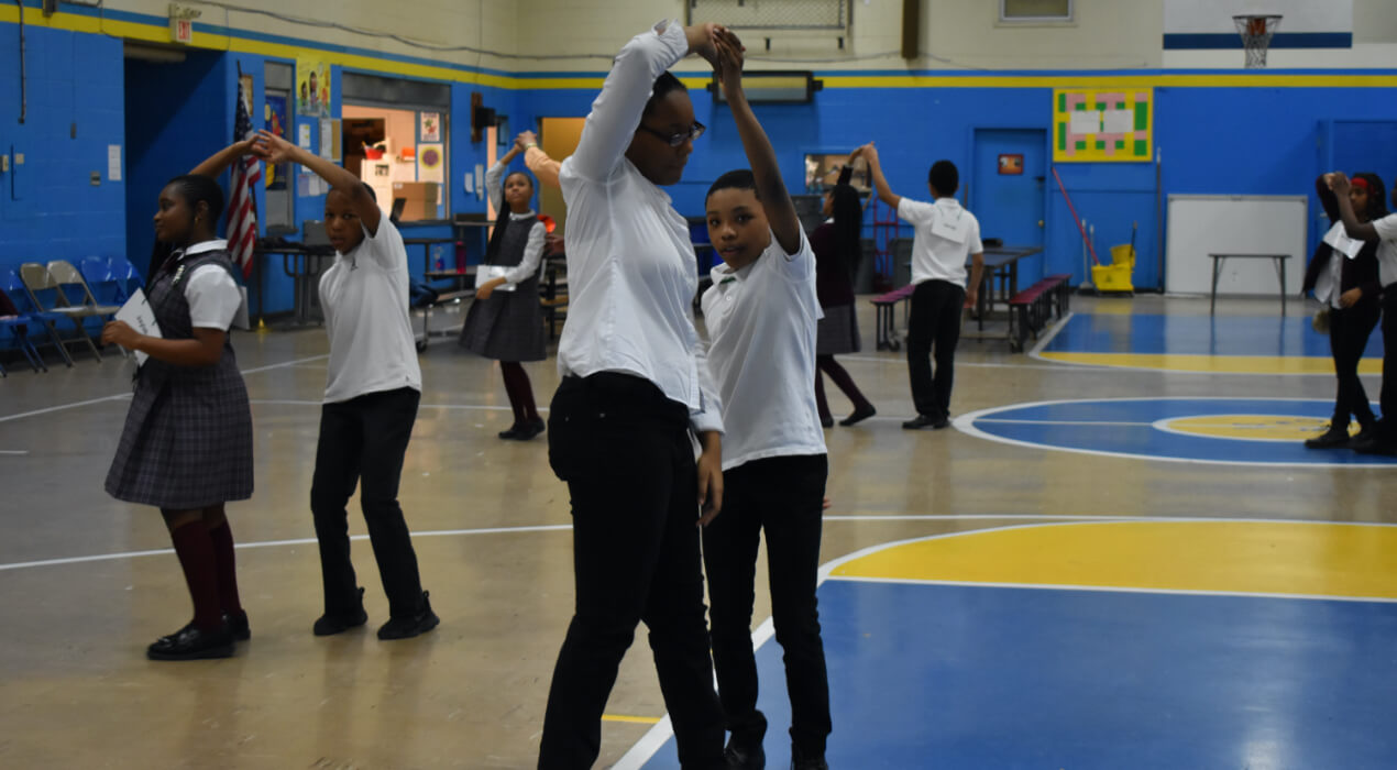 Students Learning how to dance in the gym