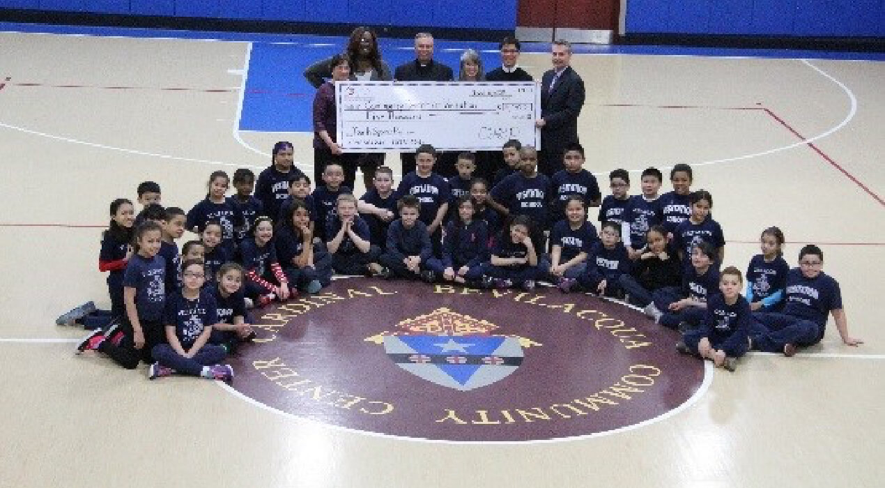 Community Center at Visitation receiving their grant in the gym