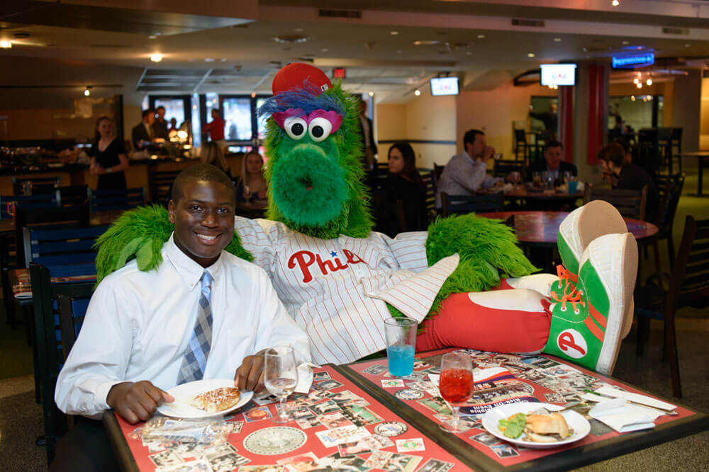 Phillie Phanatic posing with a CAC member during lunch