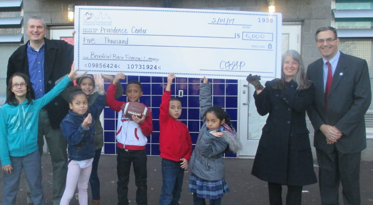 Children from the Providence Center receiving their grant