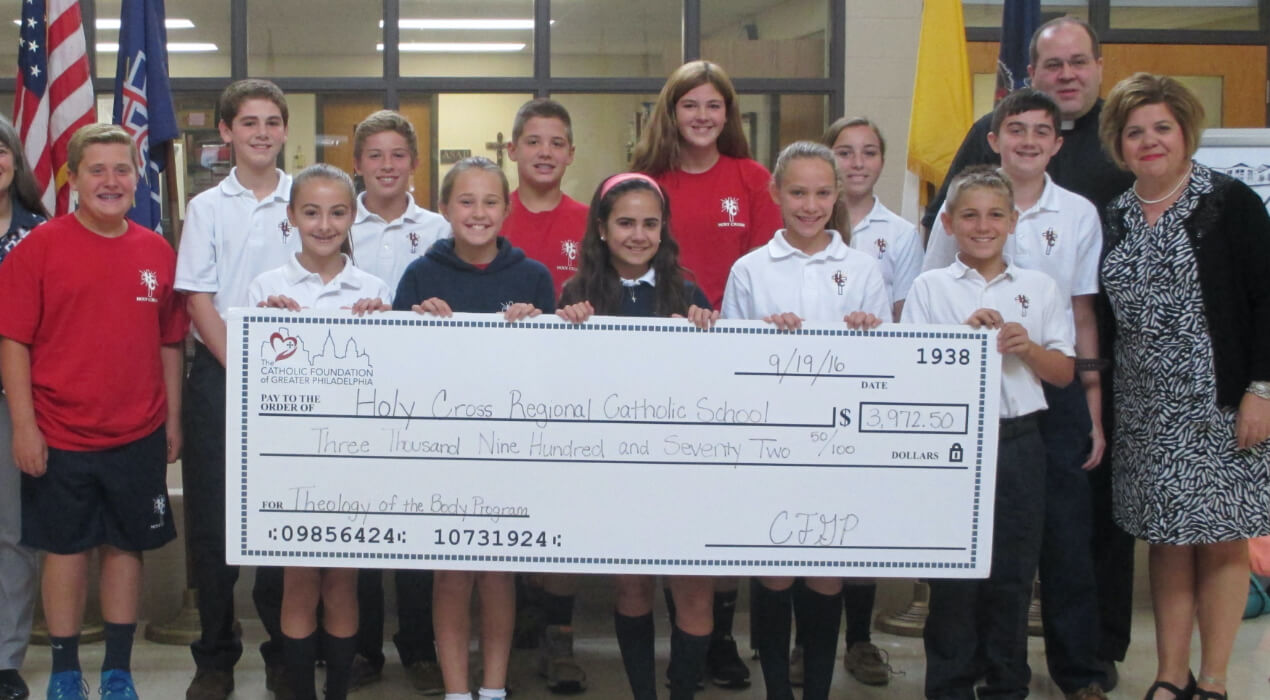 Students from Holy Cross Regional Grant receiving their grant